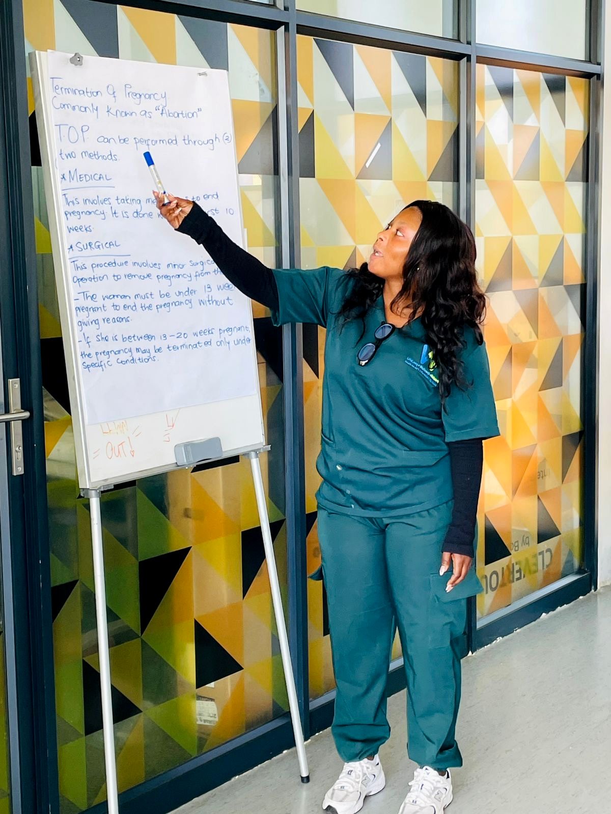 Facilitator presenting health education at a whiteboard