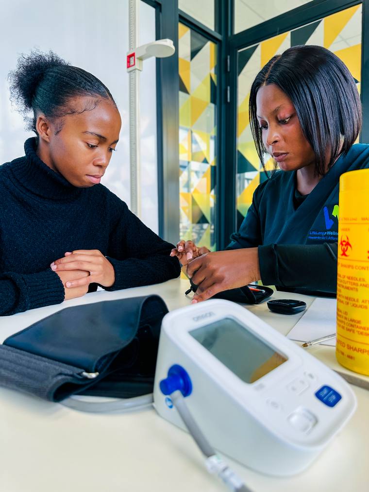 Practitioner taking a client's blood pressure